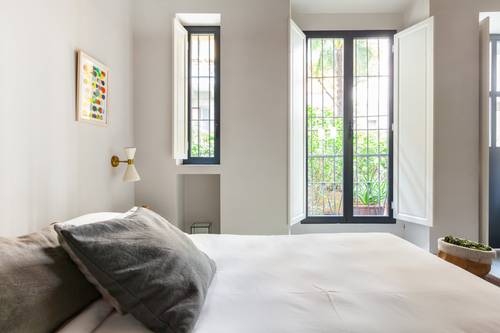 Light spills into the bedroom from the huge windows