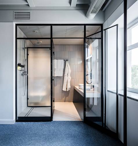 One of the bathrooms is conceived as a modern glass box.