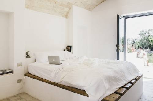 A guest bedroom looking out on an external courtyard